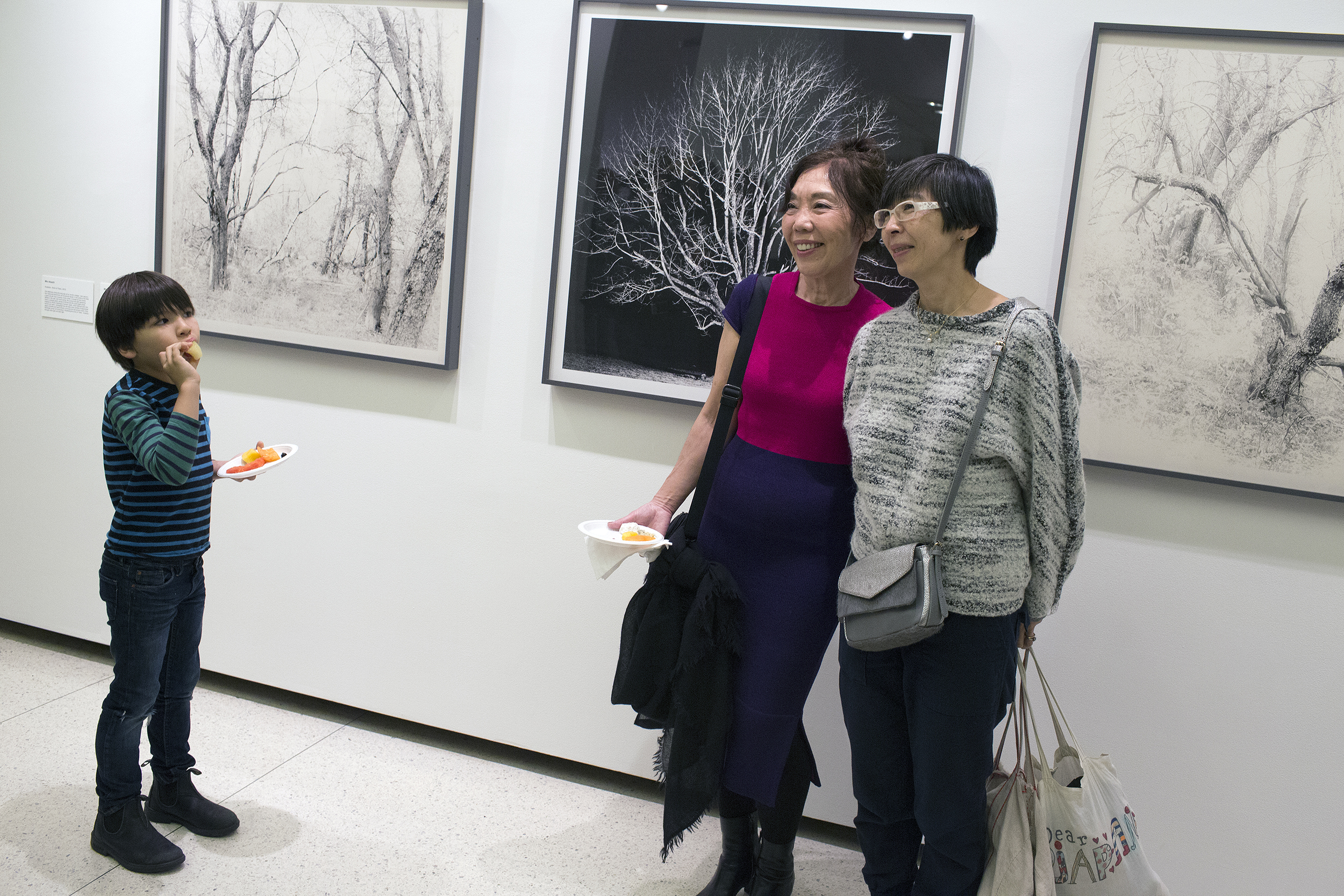 Photographer Mio Akashi and guests in front of images from her series "Tree Echo". Photographer Mio Akashi and guests in front of images from her series "Tree Echo".