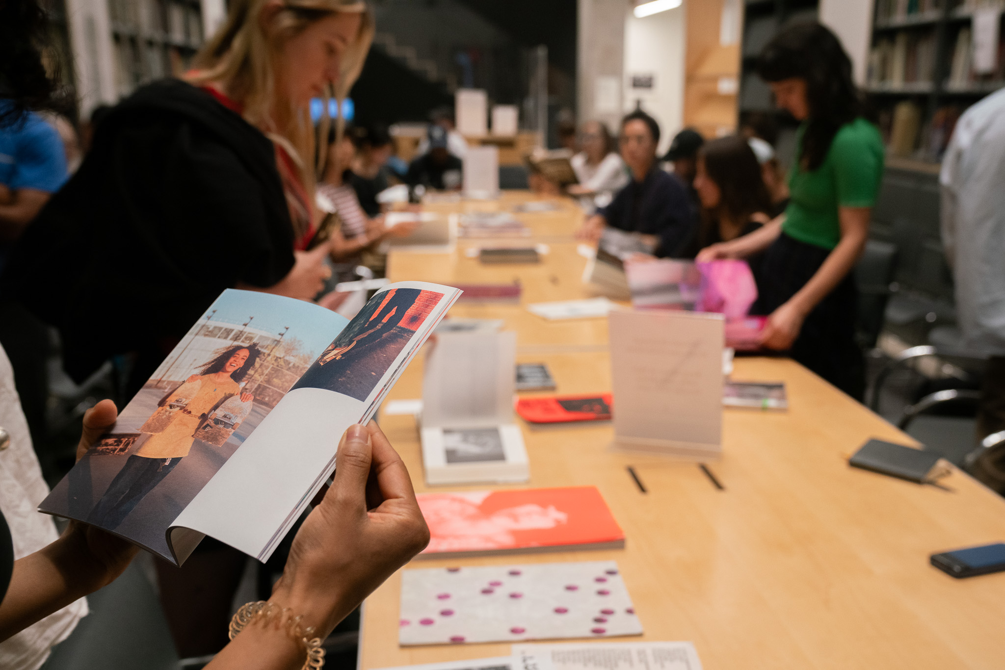 people looking at photobooks