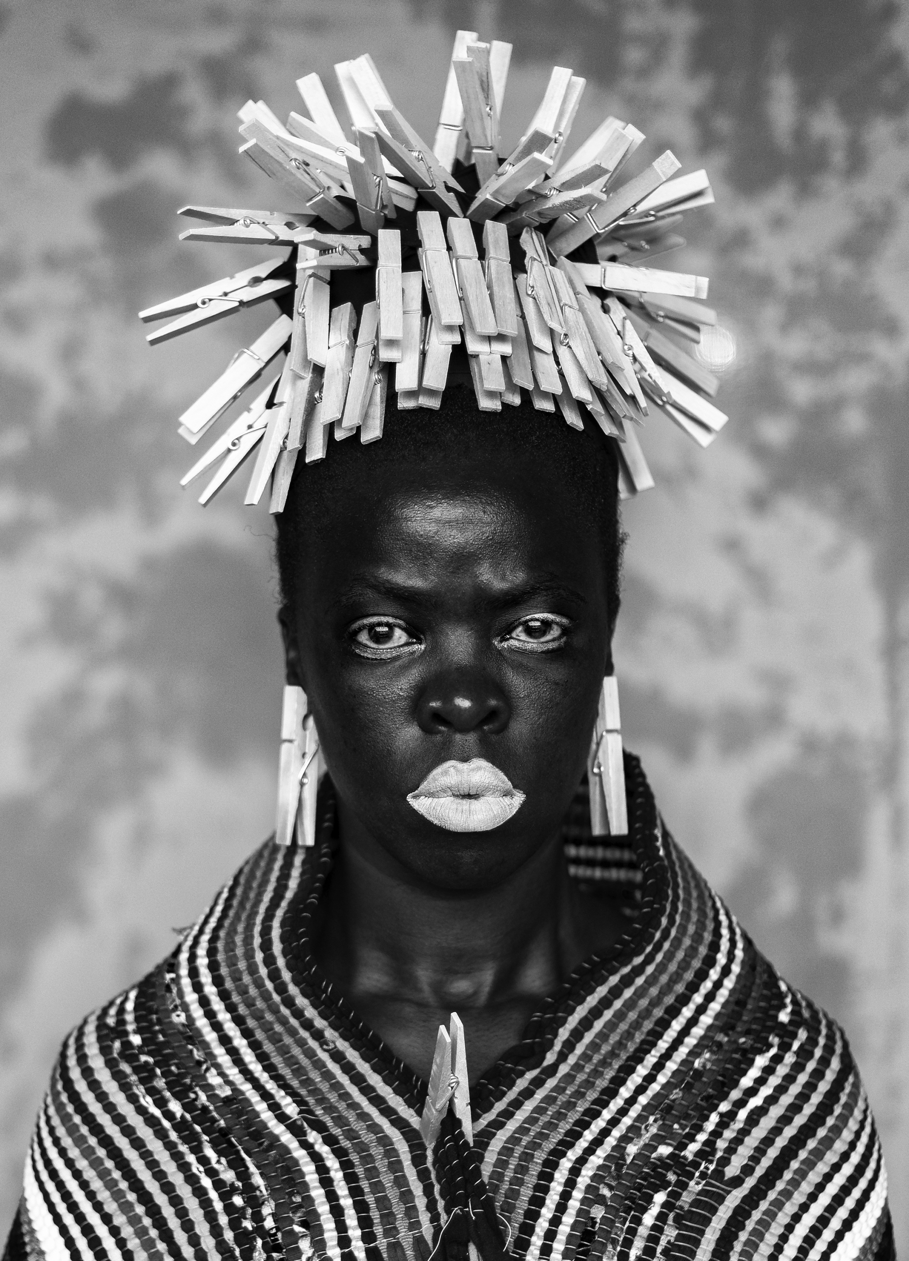 Self-portrait of Zanele Muholi wearing clothespin headdress.