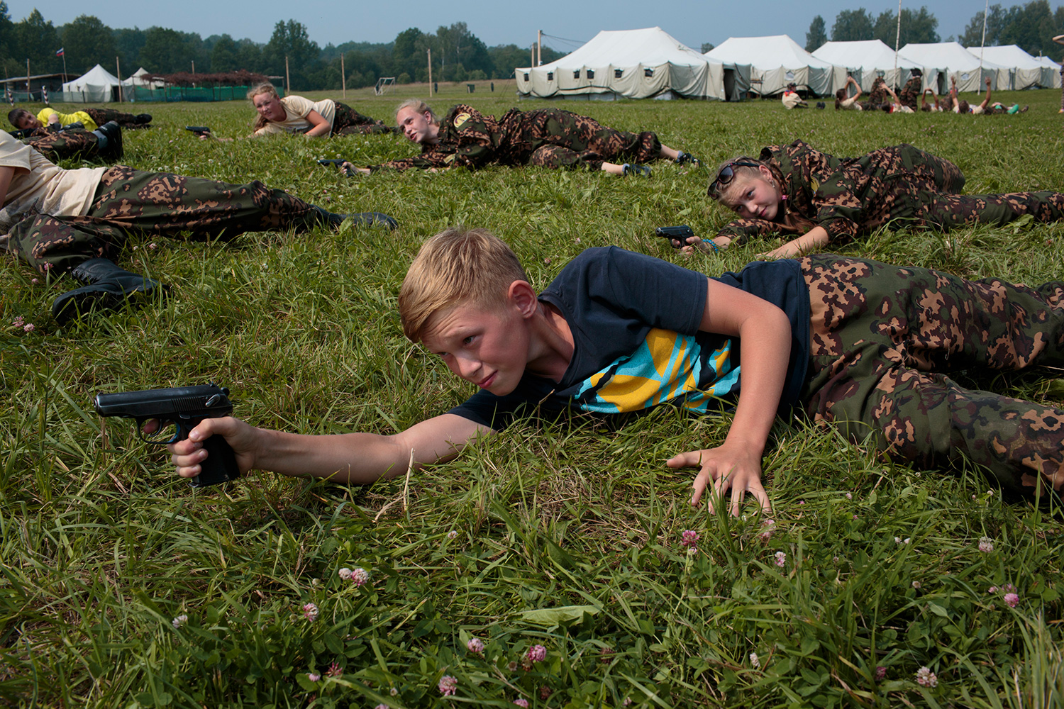 Students train in firearms at the Historical War Camp, in Borodino, Russia. July 24, 2016. Borodino is famous for a battle fought on September 7, 1812—the deadliest day of the Napoleonic Wars. Three hundred fifty adolescents are in attendance, ranging in ages from 11 to 16. They use air-soft guns for practice and competition. © Sarah Blesener Students train in firearms at the Historical War Camp, in Borodino, Russia. July 24, 2016. Borodino is famous for a battle fought on September 7, 1812—the deadliest day of the Napoleonic Wars. Three hundred fifty adolescents are in attendance, ranging in ages from 11 to 16. They use air-soft guns for practice and competition. © Sarah Blesener