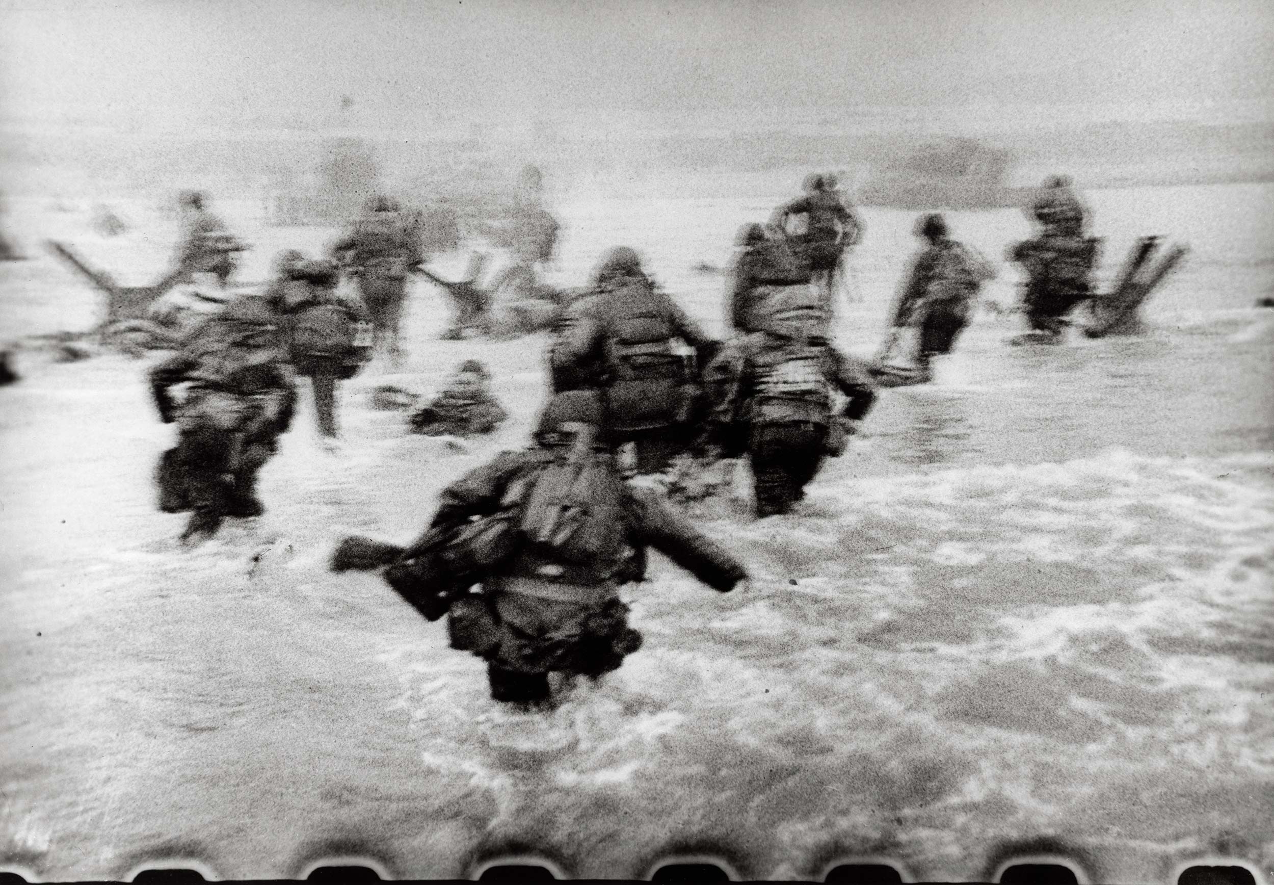 Robert Capa, [American soldiers landing on Omaha Beach, D-Day, Normandy, France], June 6, 1944. © International Center of Photography/Magnum Photos