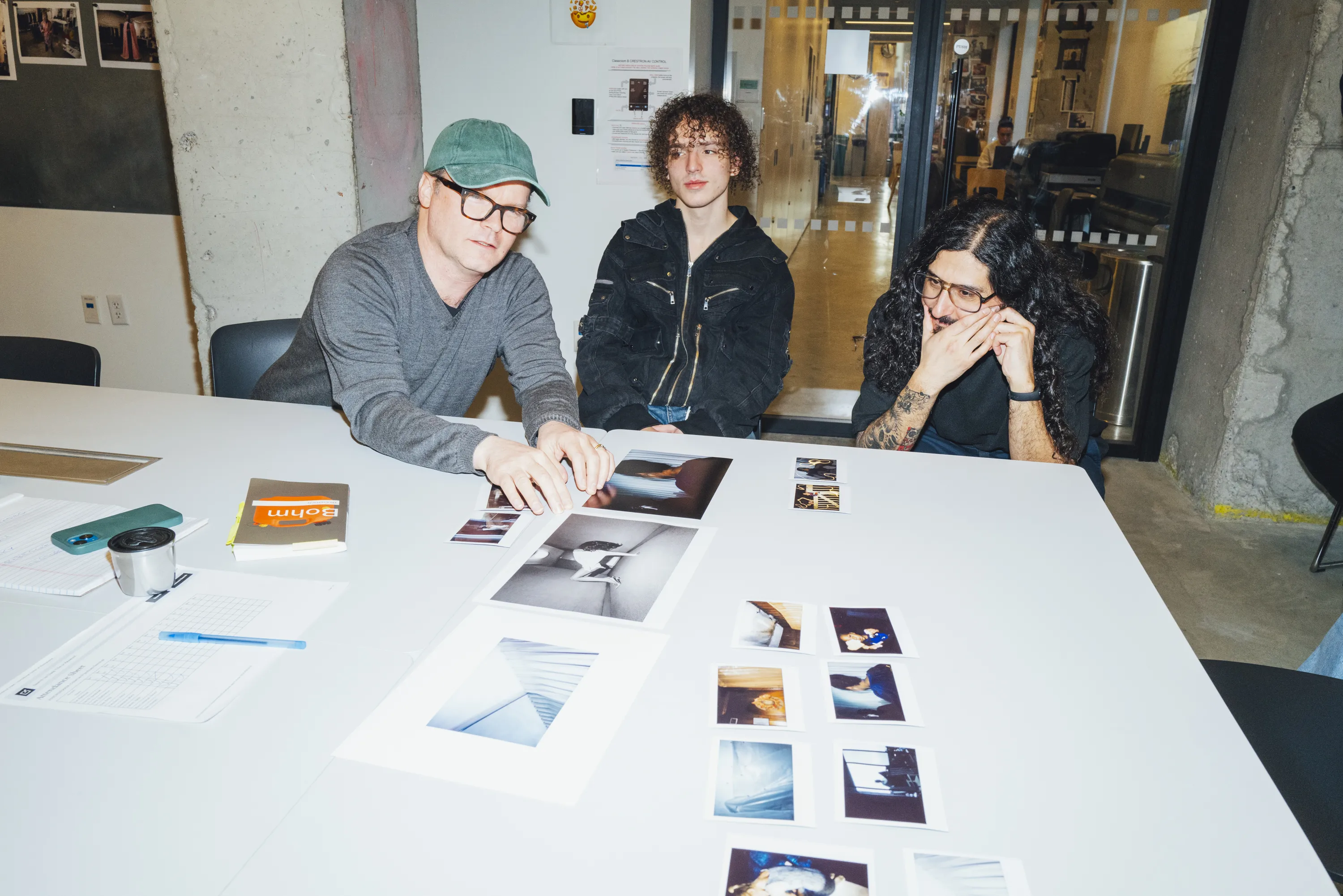 Program chair looking at images with students in classroom