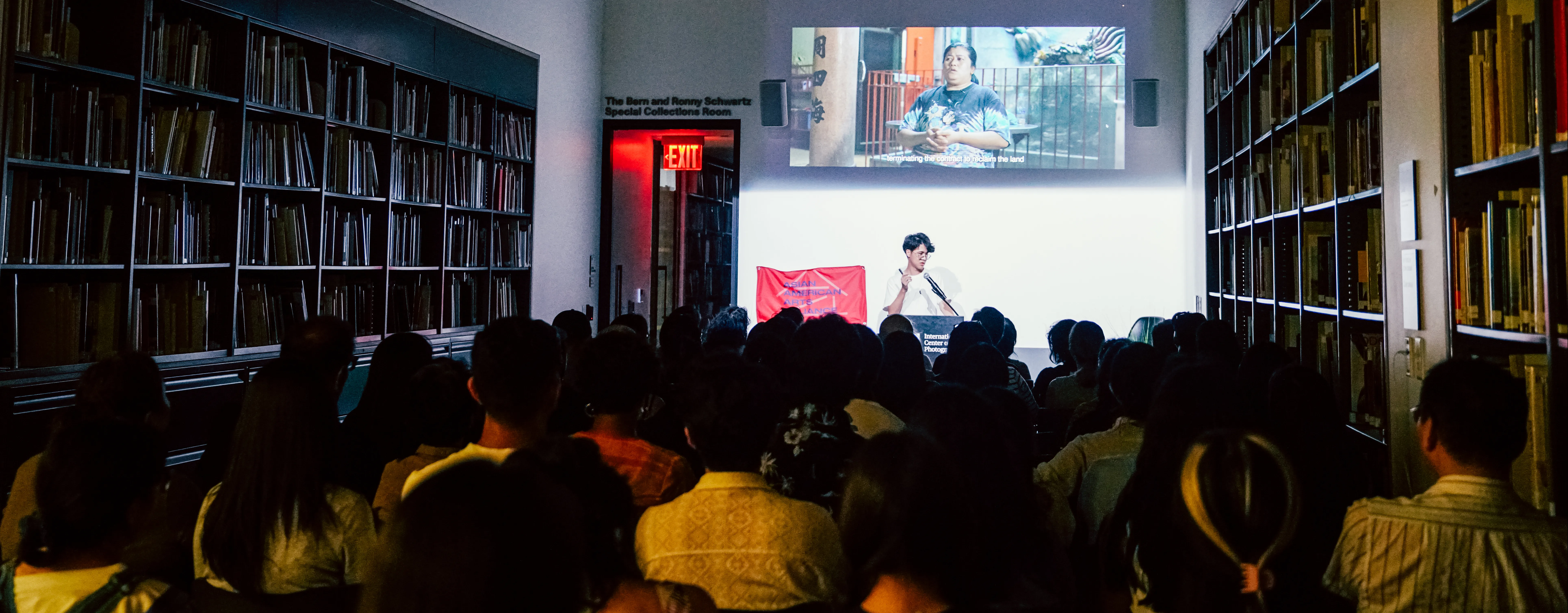a person talking in front of crowded