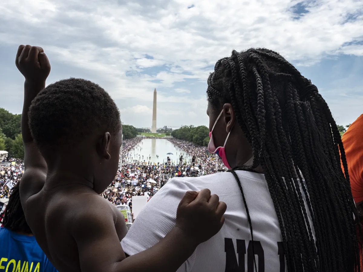 A black woman and her son at a protest at the Lincoln memorial. 