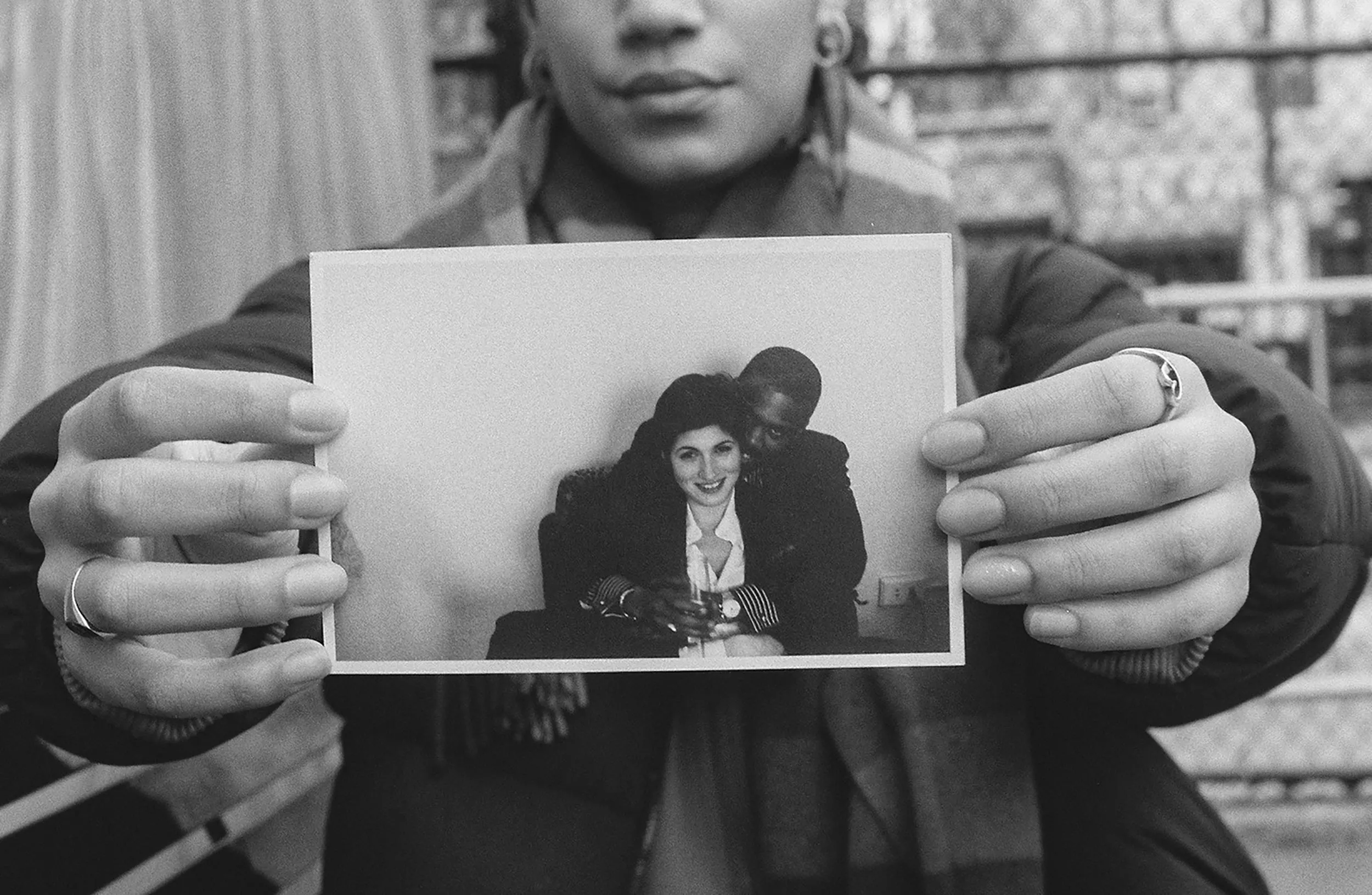 Picture of a girl holding a photo up.