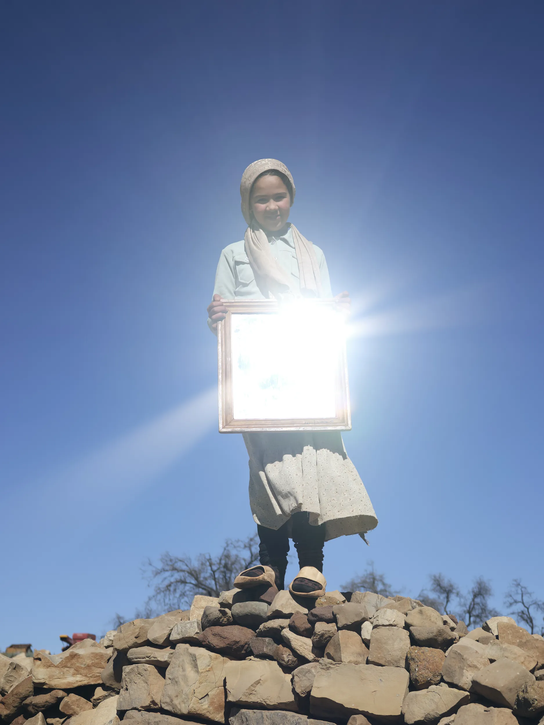 Marwa reflects the sun in a mirror from her childhood room  2025 - Lee-Ann Olwage. 