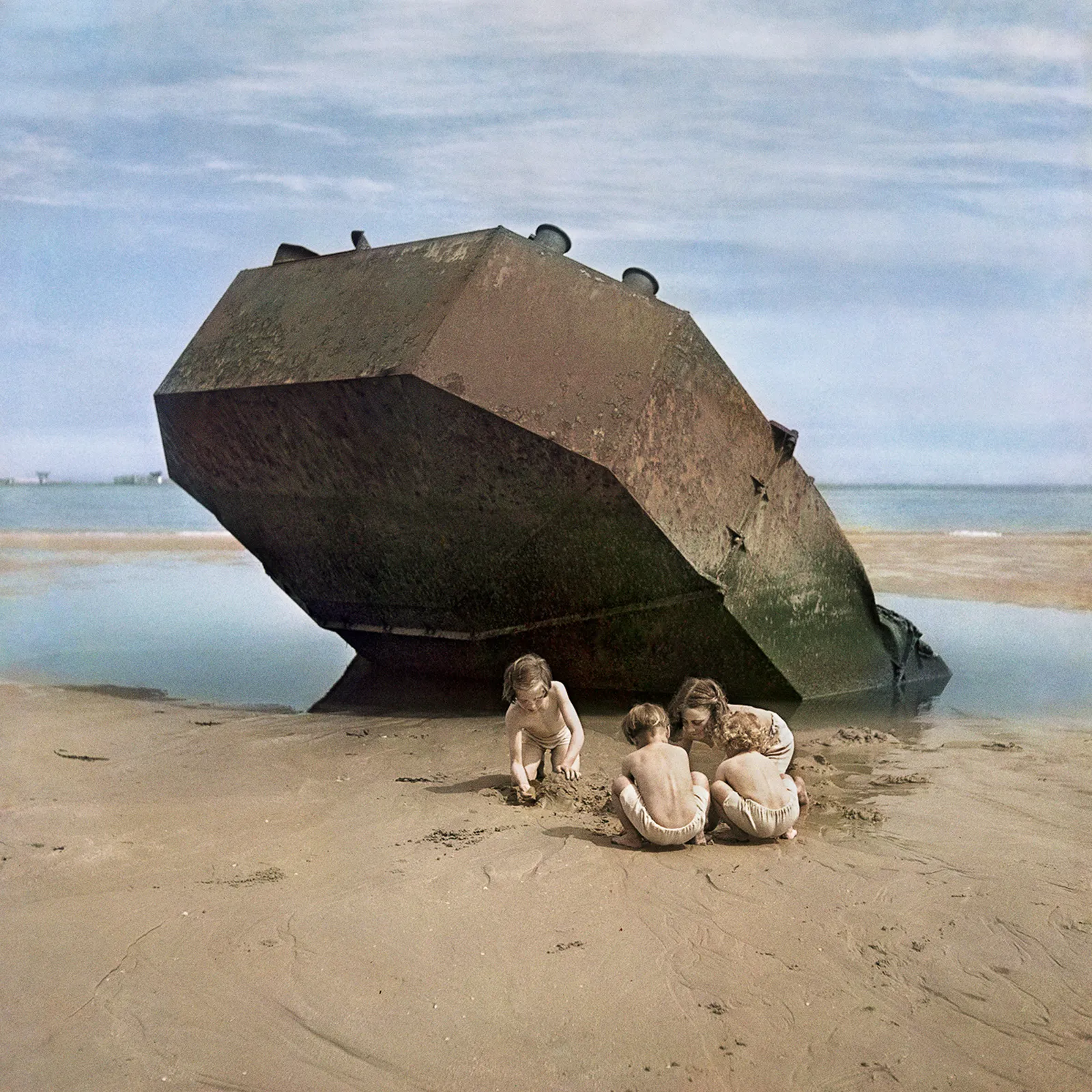 Four kids playing at the beach.