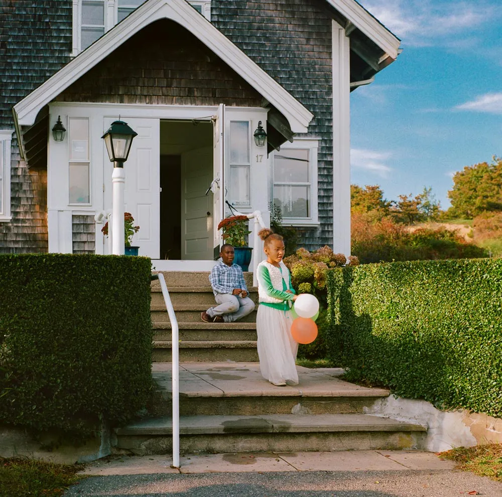 Two kids playing outside the house