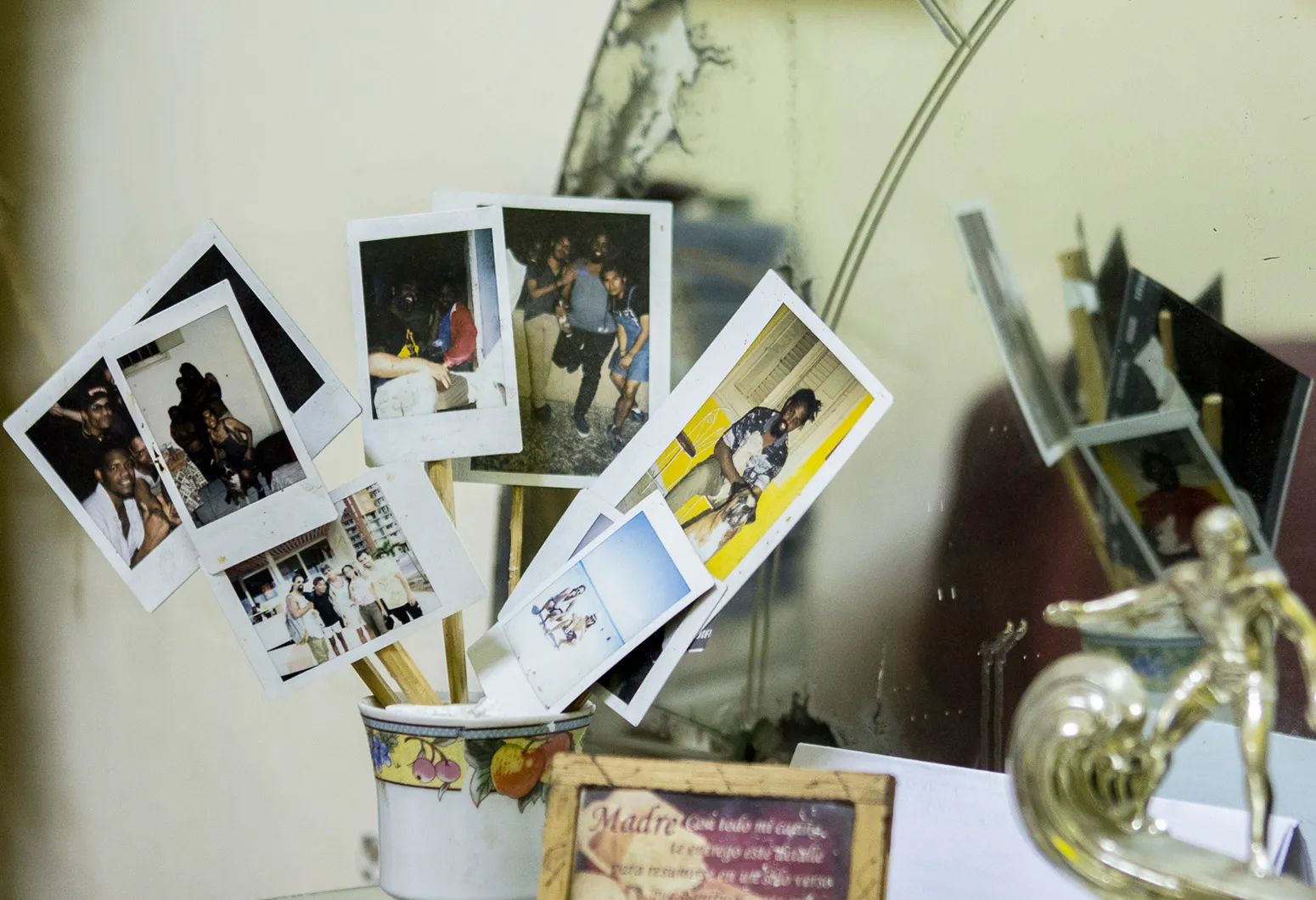 Picture of someones top dresser with polaroids