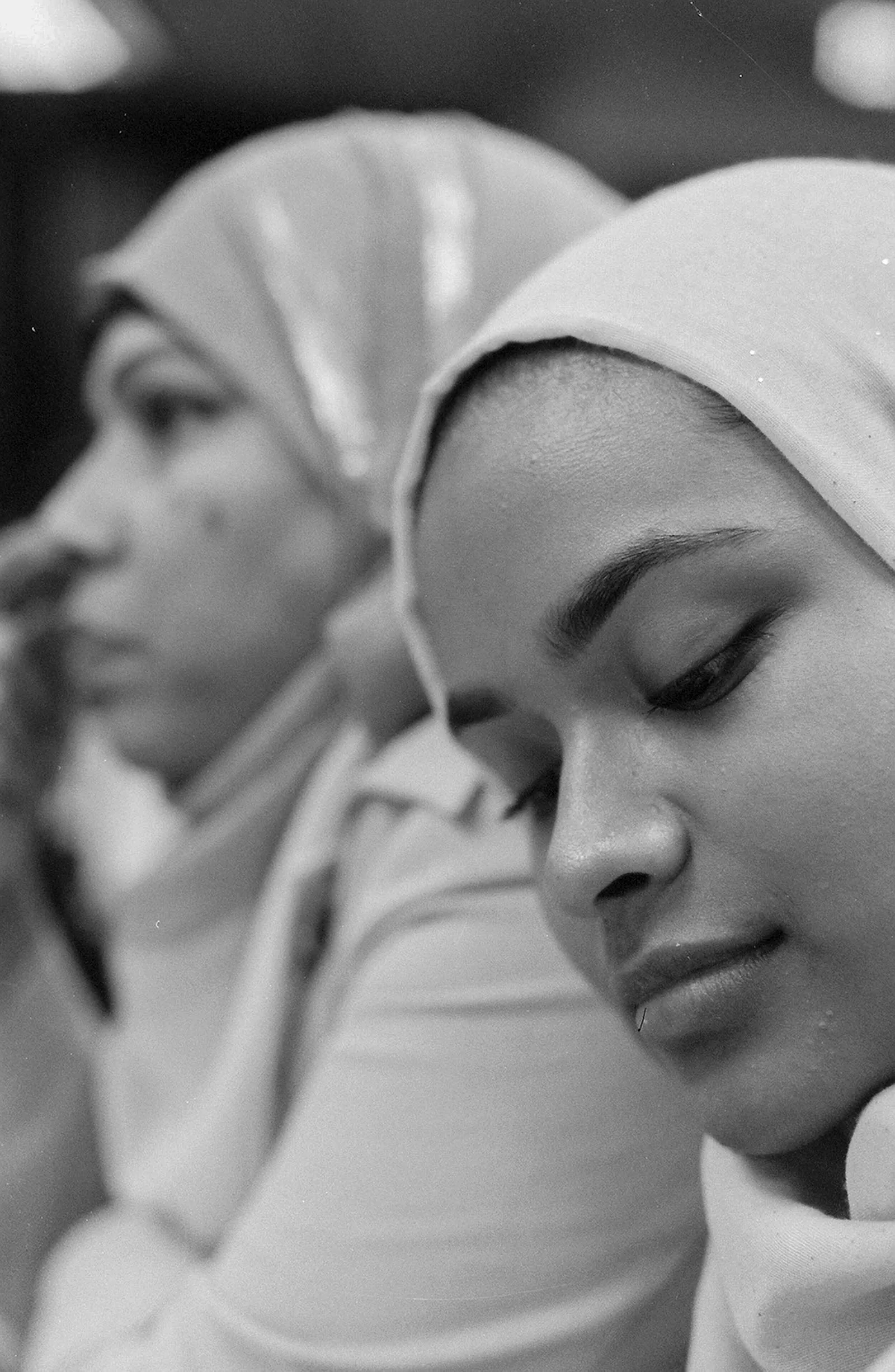 A black and white image of 2 ladies with hijabs