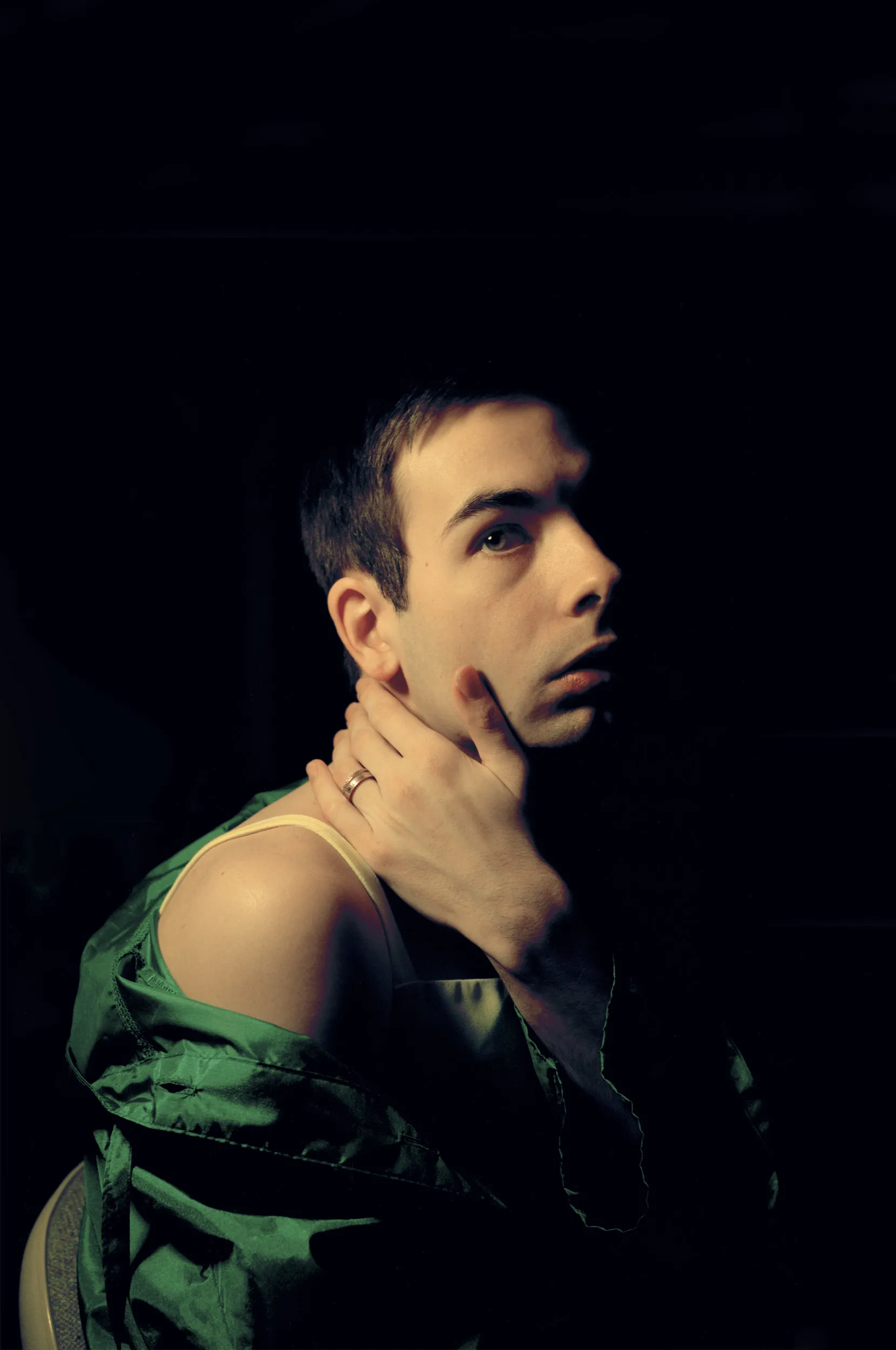A person posing and holding their neck.