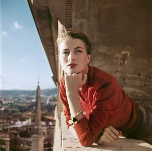 A woman looking out of the balcony.