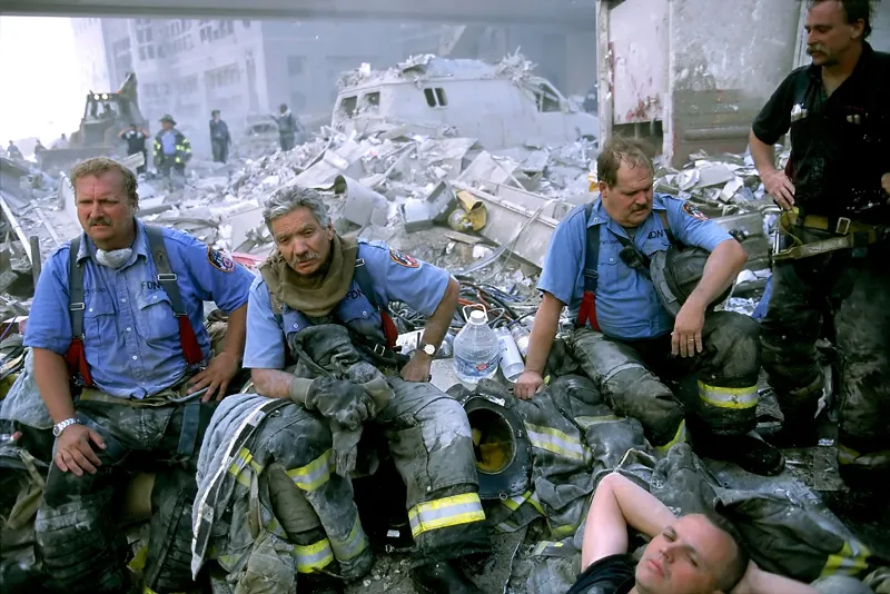 A group of firefighters outside of a disaster.