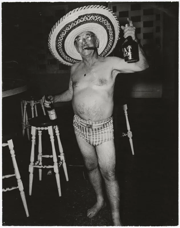 A guy at a bar half naked.
