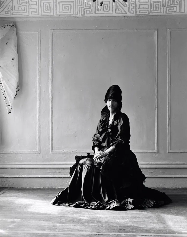 A picture of a person in a dress looking at the camera.