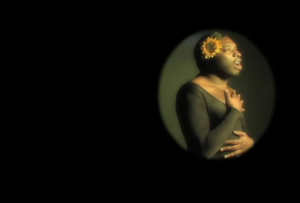 A man with a sunflower in his ear.