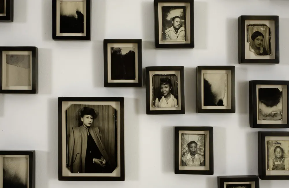 A collection of older framed images hung up. 