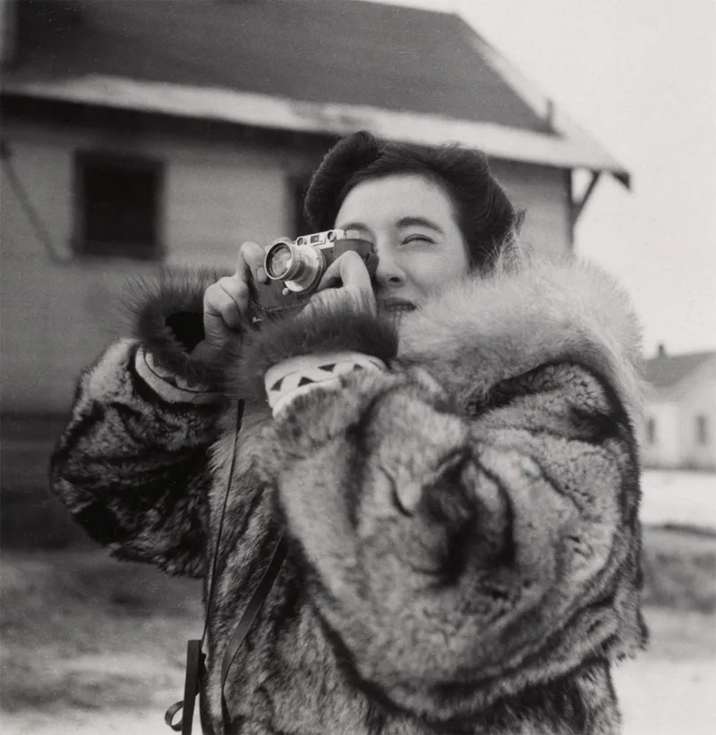 An Inuit using a camera. 