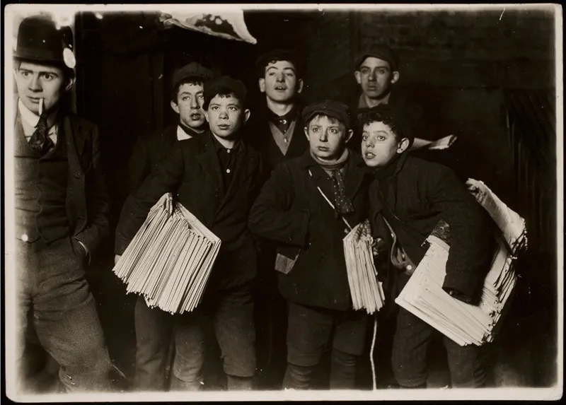 Newspaper boys looking at something off screen. 