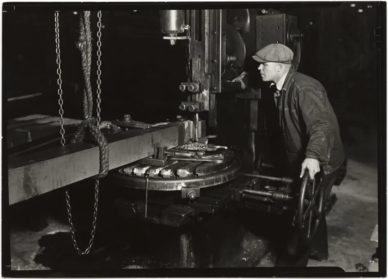 A factory worker and his machine. 