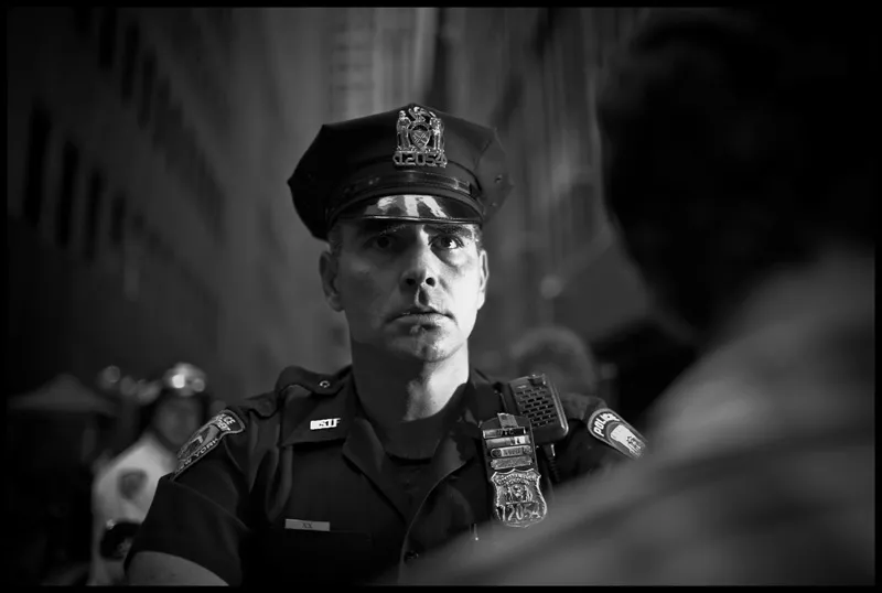 A stern cop with a look of concern in his eyes. 