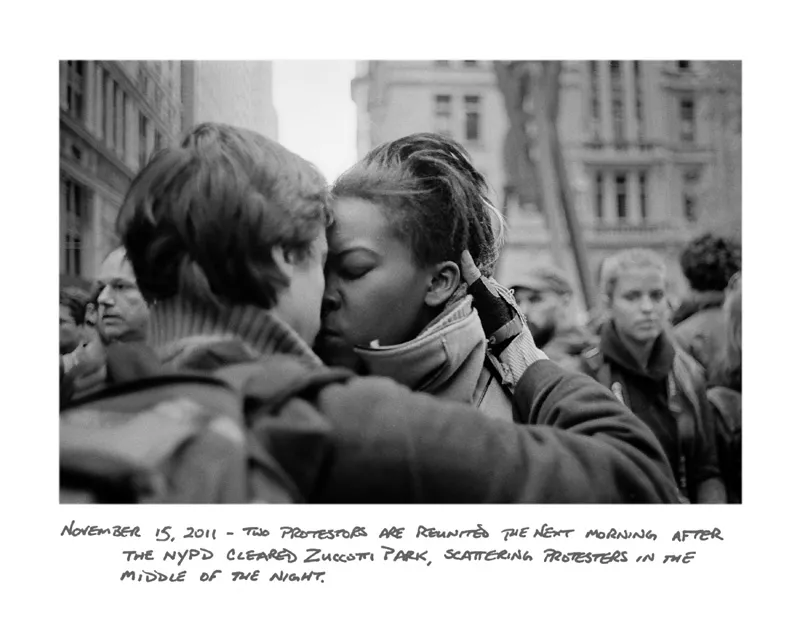 Protestors embracing each other lovingly in an Occupy Wall Street protest. 