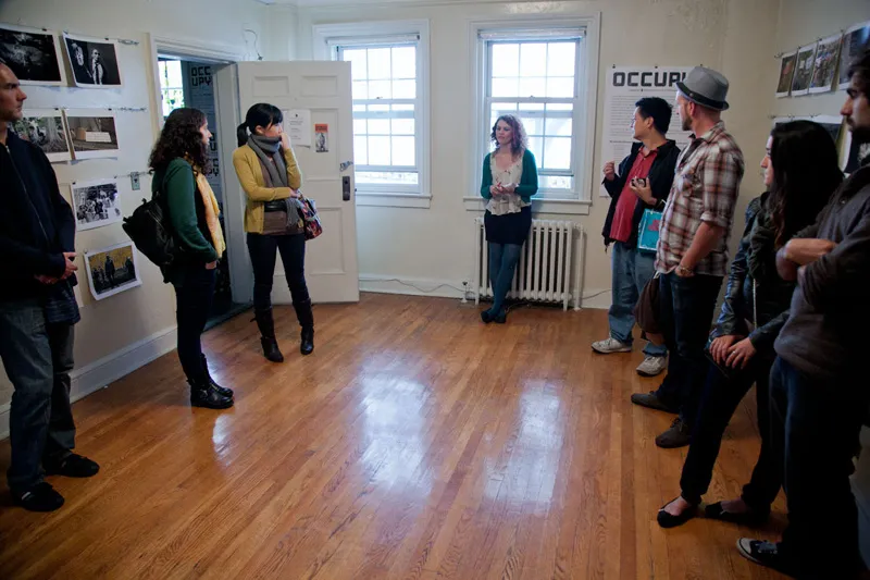 A lecture occurring in a photography exhibit. 