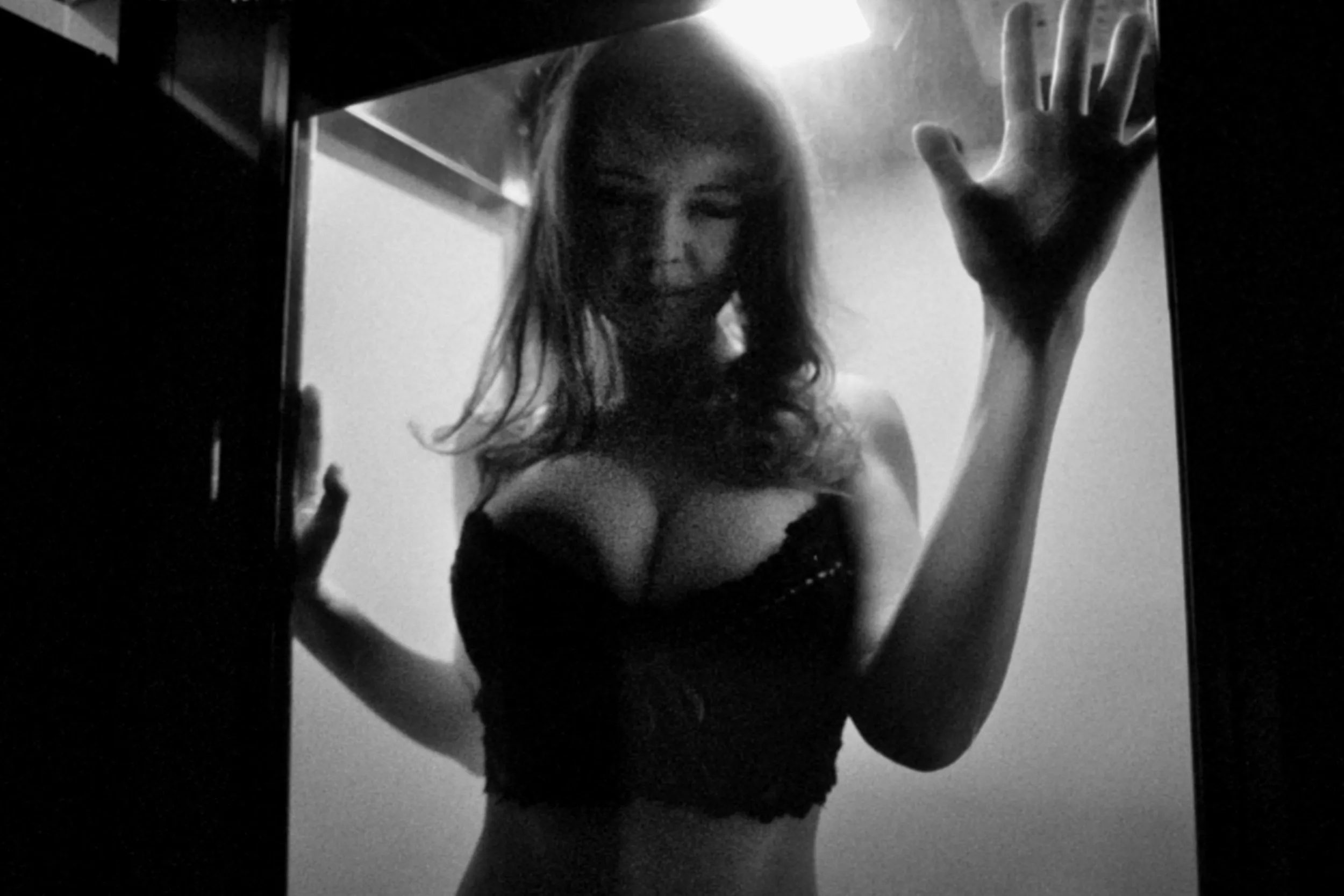 Image of a women pressed upon glass