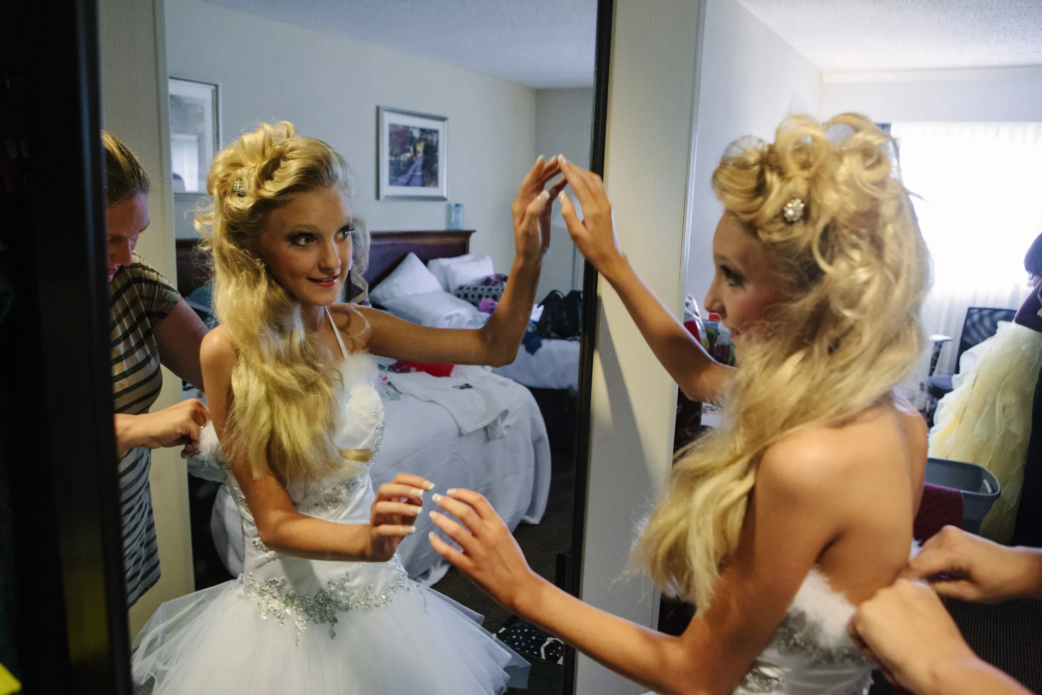 Girl trying on a dress in front of mirror