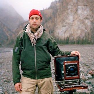 A man next to a camera.
