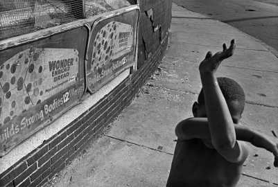 Kid hiding his face outside