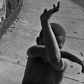 Kid hiding his face outside
