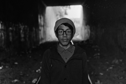 Guy standing on railroad tracks in tunnel