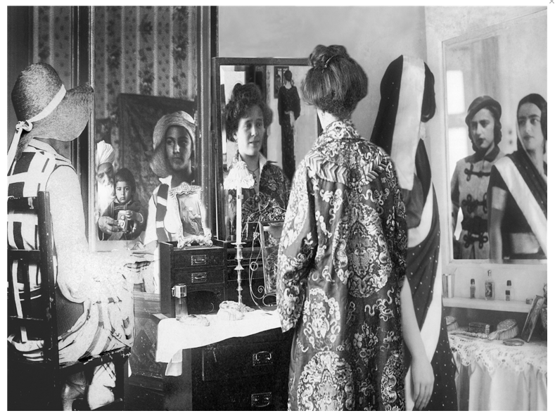 A lady looking into a mirror.