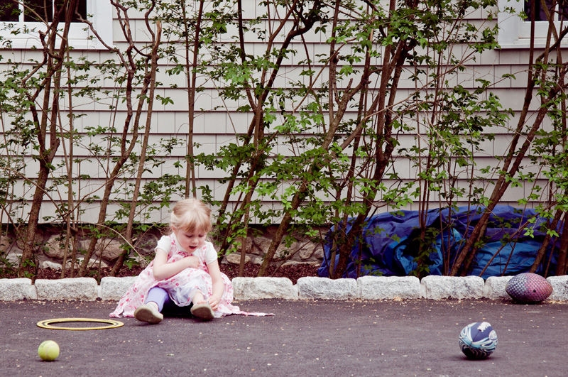 A baby sitting on the floor.