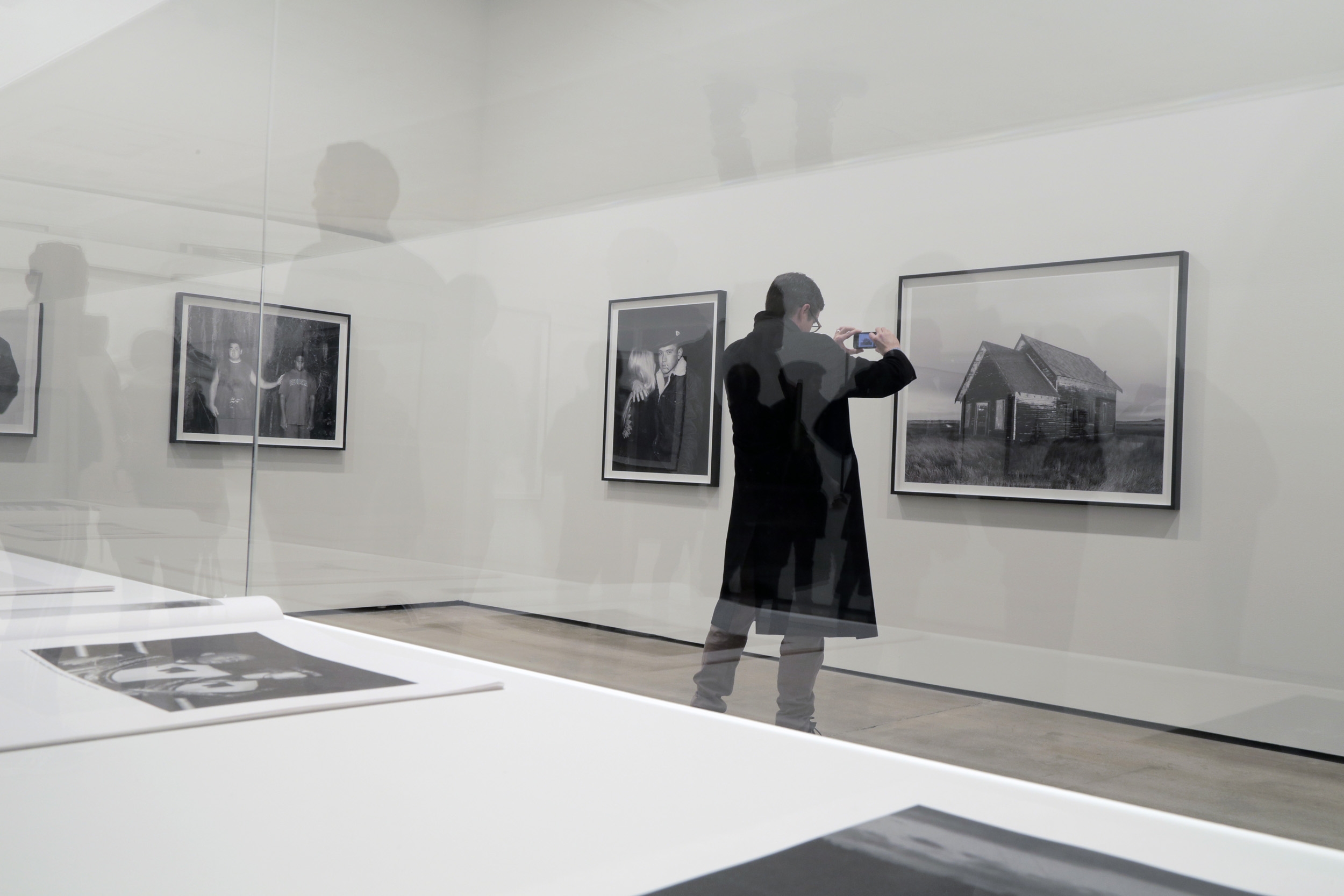 A person looking at art on the wall.