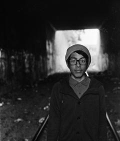  A person standing inside a tunnel.