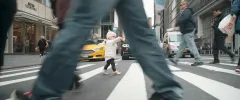 A baby crossing the street.