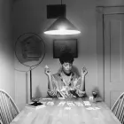 A woman playing cards on her own.