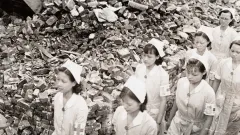 Nurses walking next to debris.