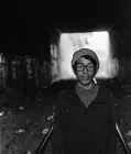  A person standing inside a tunnel.
