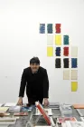 A man in front of art supplies.