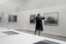 A person looking at art on the wall.