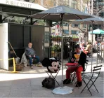 A man in a mickey mouse costume sitting down.