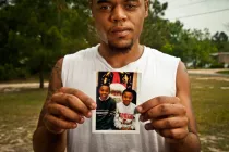 A man holding up a picture.