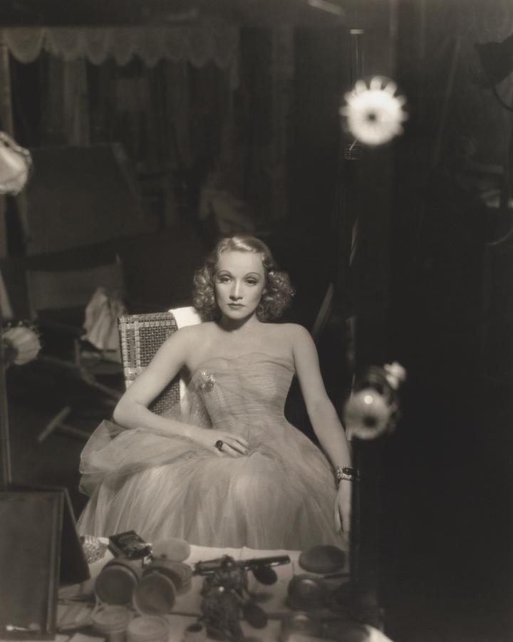 Dietrich sitting down, gazing at herself in the mirror. 
