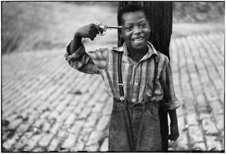 A kid holding a gun to his head.