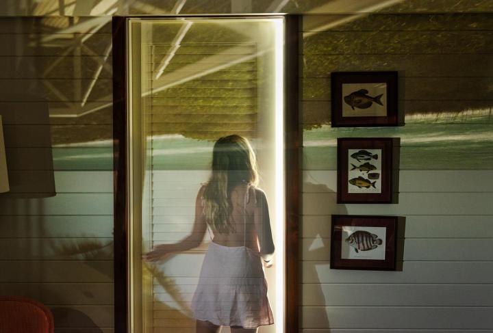 A girl going through the door.