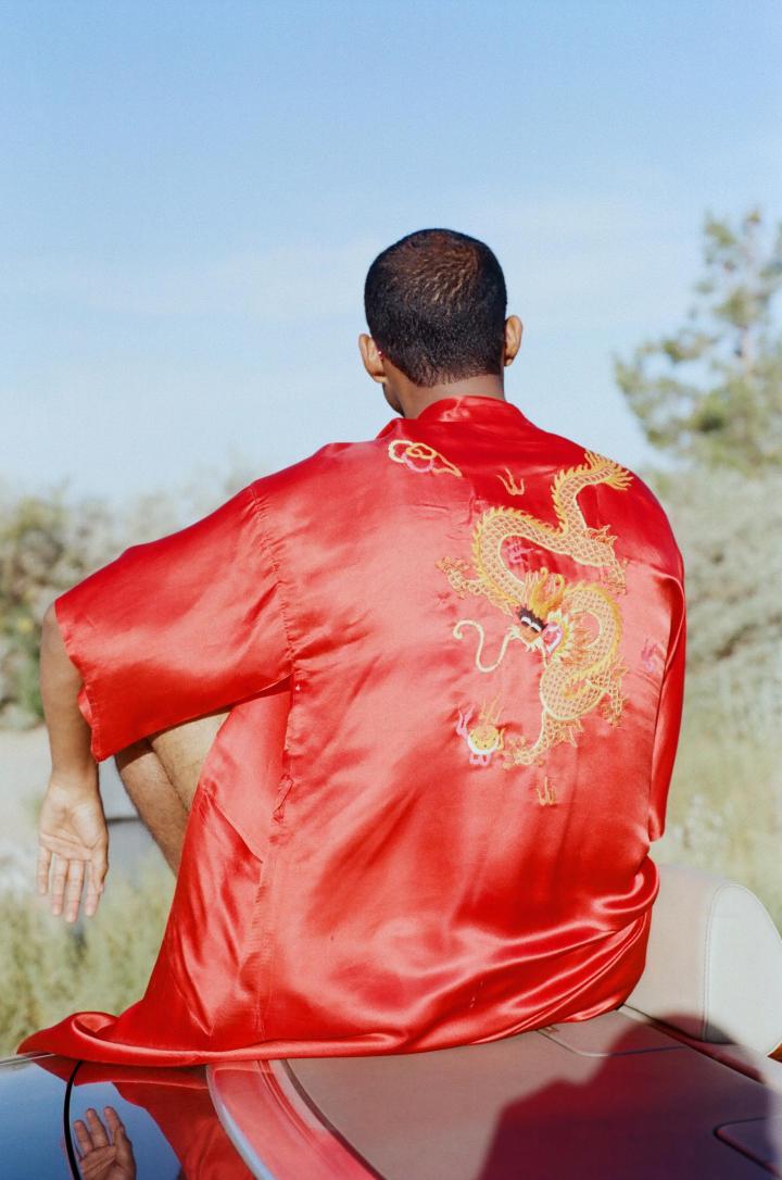 A man with a red dragon shirt.