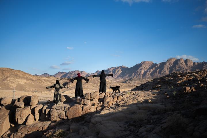 Three people outside in the desert.